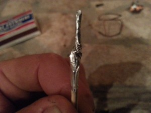 6- twist the tinfoil and squeeze tightly around the match